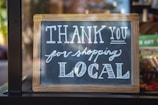 shallow focus photo of thank you for shopping signage