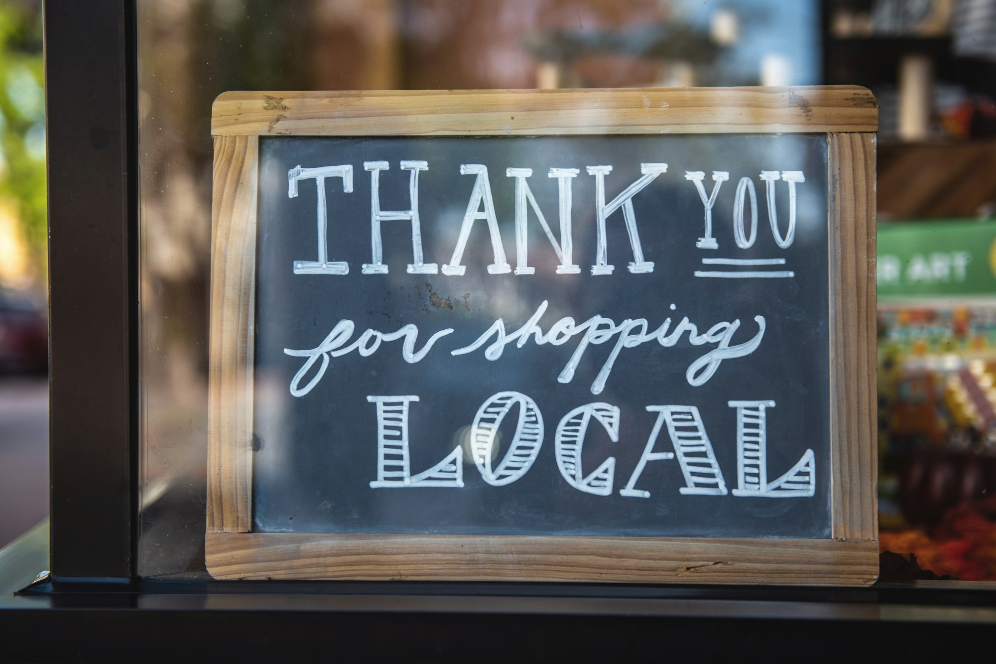 thank you for shopping sign on the front of a small business