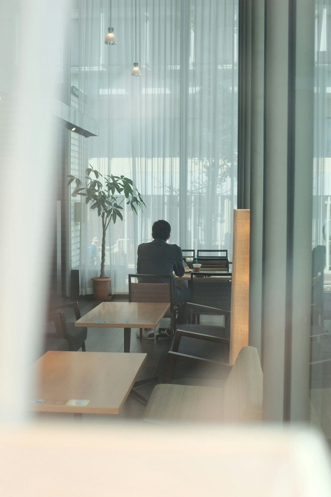 man sits on chair near wall