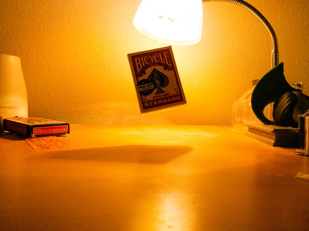 a desk with a lamp and a book on it