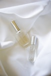 two bottles on white textile