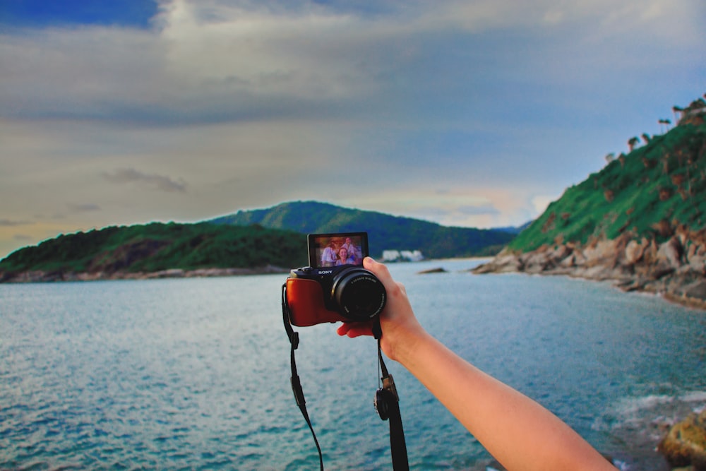 wide-angle photography of mountain range and seashore during daytime