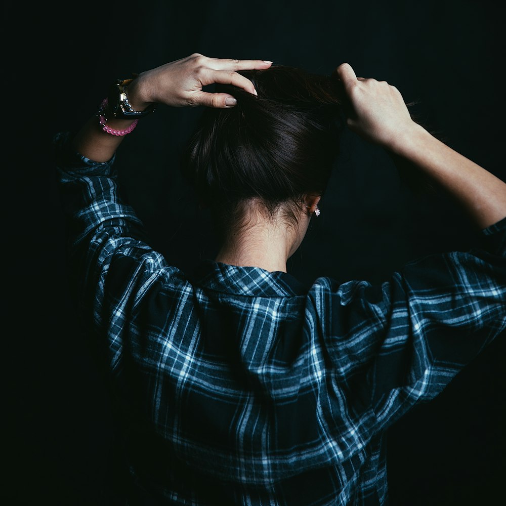 a woman with her hands on her head