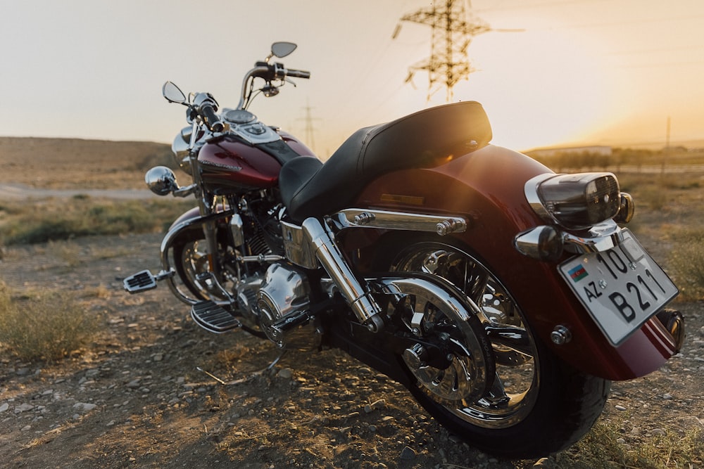 a red motorcycle parked on a dirt road