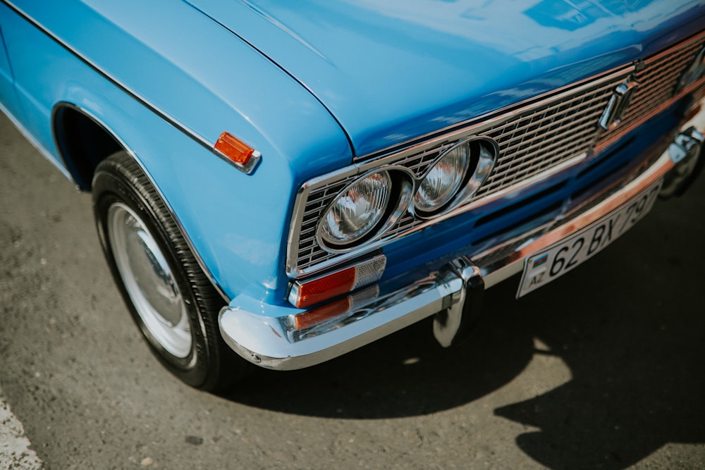 a blue car parked on the side of the road