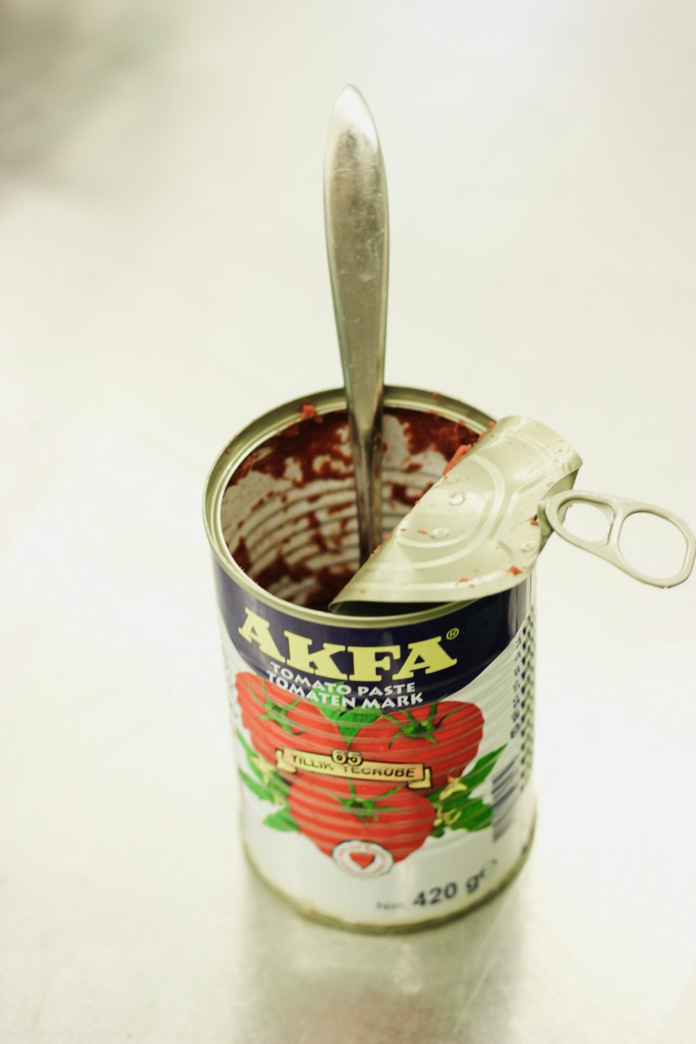 a can of food with a spoon sticking out of it