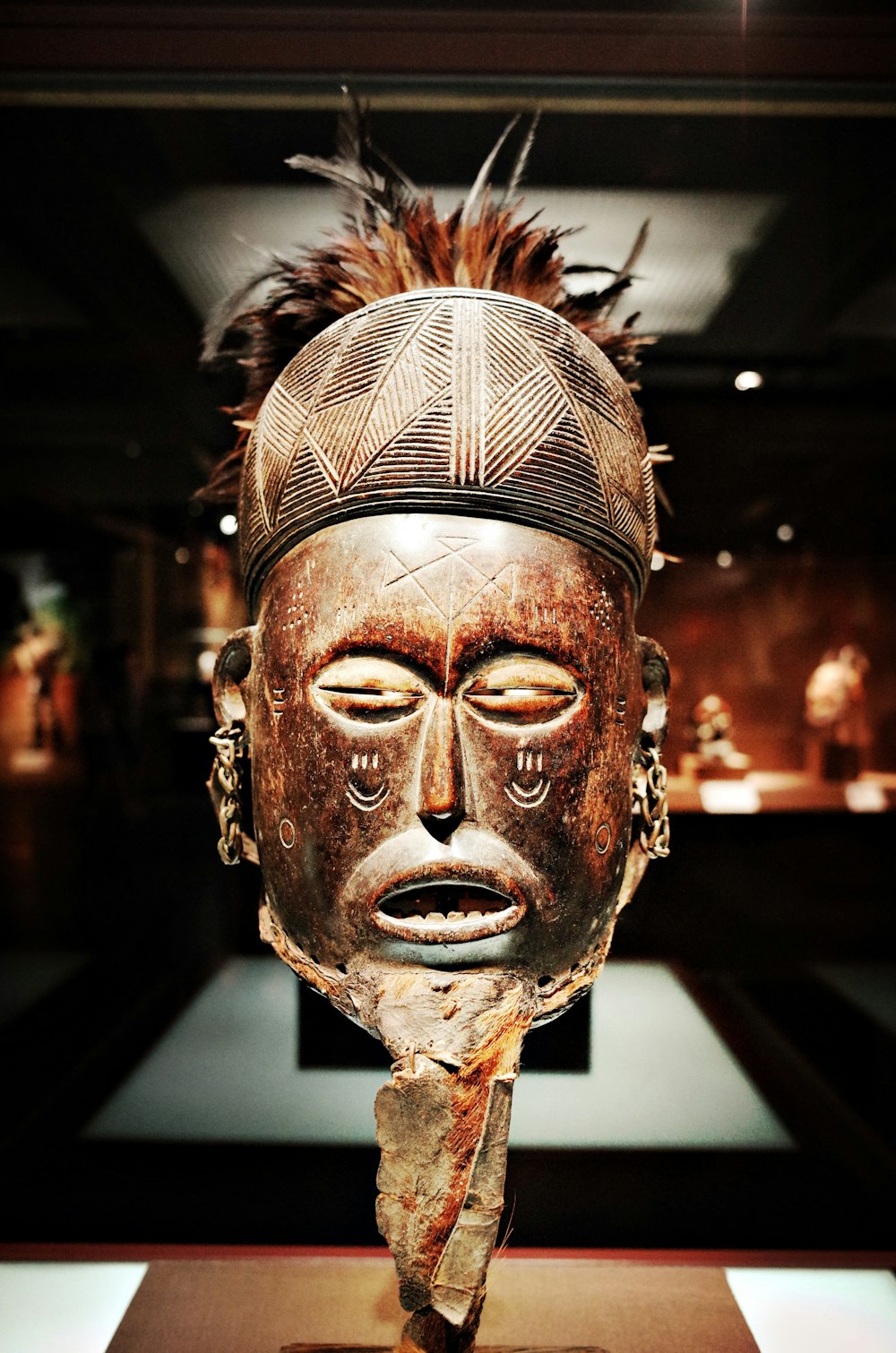 a wooden mask on display in a museum