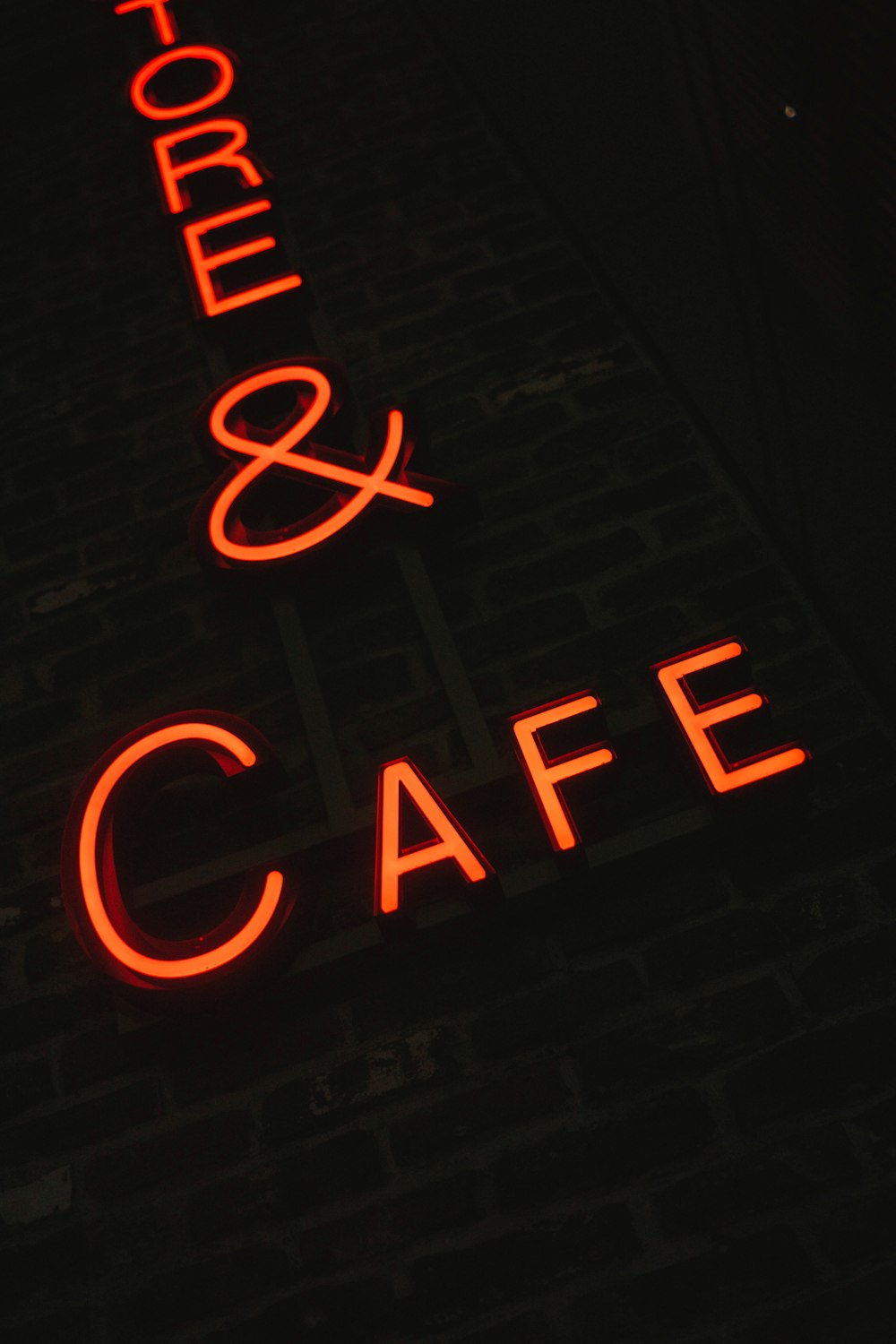 orange neon sign on wall