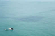 A vast platform with six numbered foundations, half submerged under dark waves.