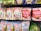 Various packaged snacks and candies are displayed on a store shelf. The packages feature colorful designs with images of fruits, beverages, and cartoon characters. The text on the packaging is in Japanese, with prominent depictions of strawberries, matcha, and milk tea.
