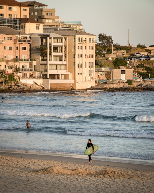 man holding surfboard in Bondi Beach NSW Australia