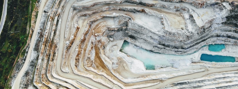 an aerial view of a quarry with a blue pool