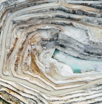 an aerial view of a quarry with a blue pool