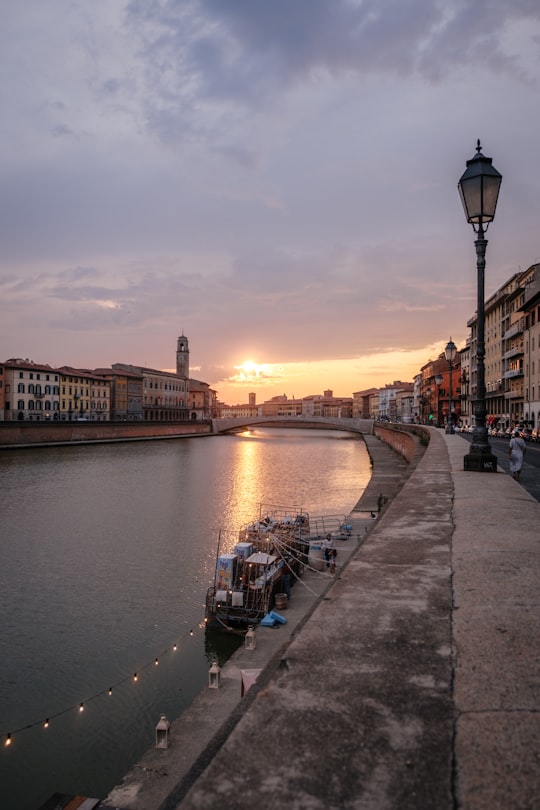 boat beside sidewalk in Pisa Italy