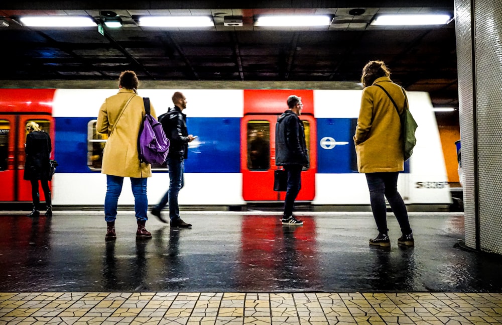 people standing beside train