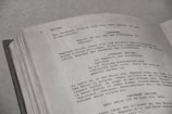 a close up of an open book with writing on it