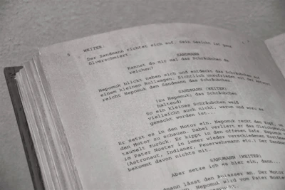 a close up of an open book with writing on it
