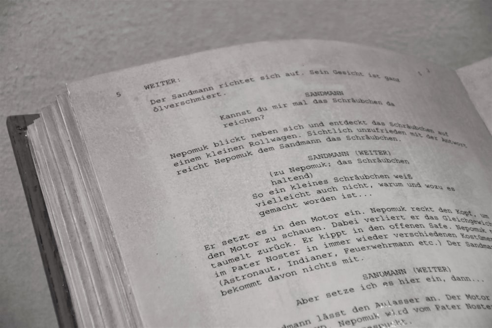 a close up of an open book with writing on it