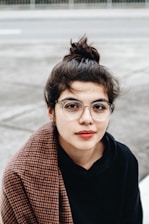 woman in black hoodie wearing eyeglasses