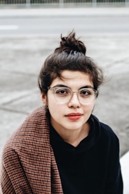 woman in black hoodie wearing eyeglasses