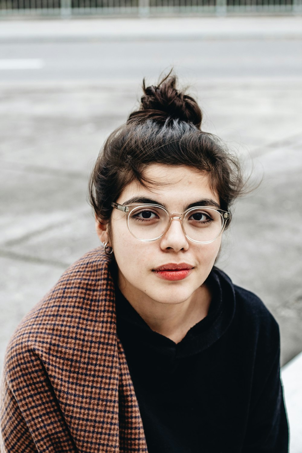 woman in black hoodie wearing eyeglasses