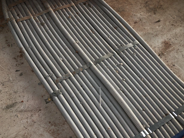 Close-up image of shiny galvanized steel coils stacked neatly.