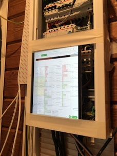 A technician analyzing smart grid data on a digital tablet in a control room.