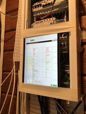 Technician configuring a smart home control panel indoors.
