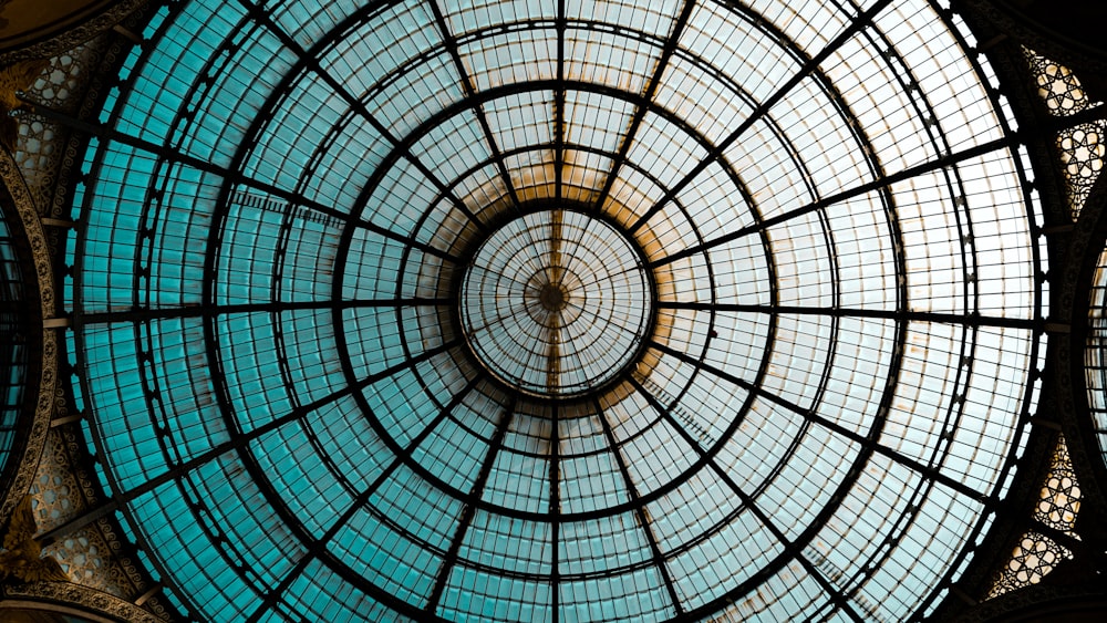 a glass ceiling with a circular design in a building