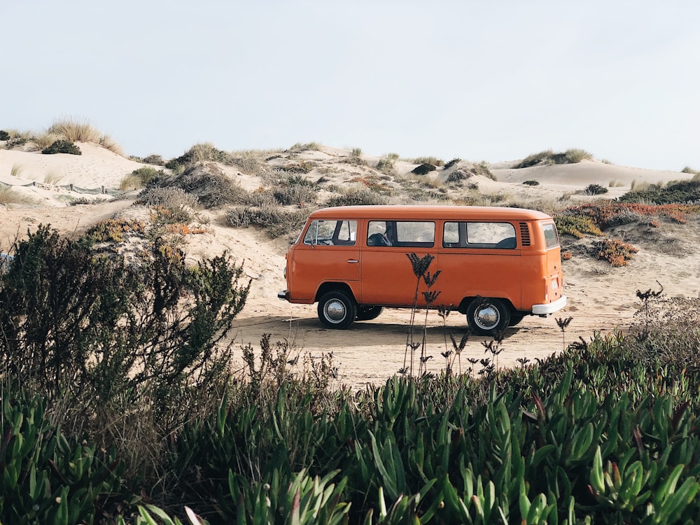 van parked on dirt field during day