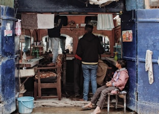 A family enjoying their time at the barbershop.