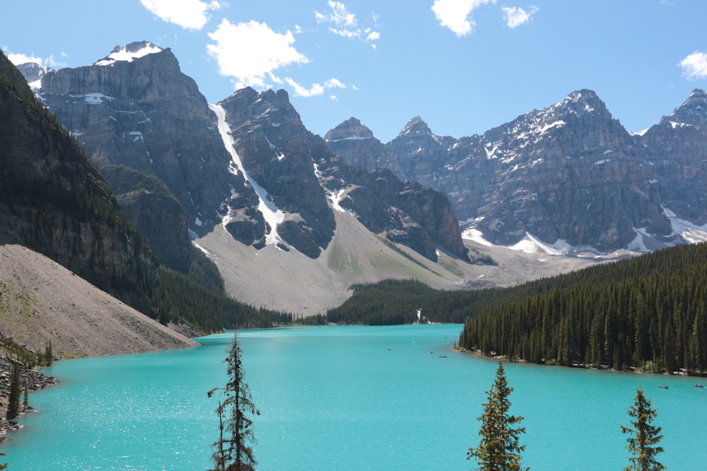 body of water near mountains at daytime