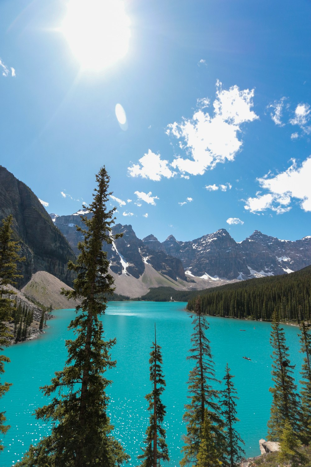 body of water near mountains at daytime