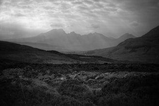 Black and white landscape capturing a quiet mist over rugged hills.