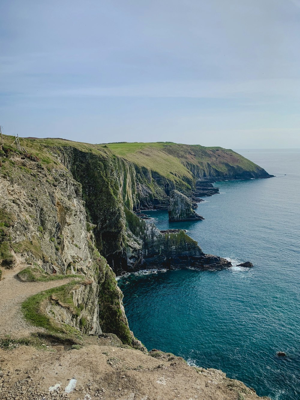 Green cliffs and pasture along the Irish coastline