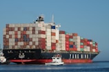 black and red ship on body of water at daytime