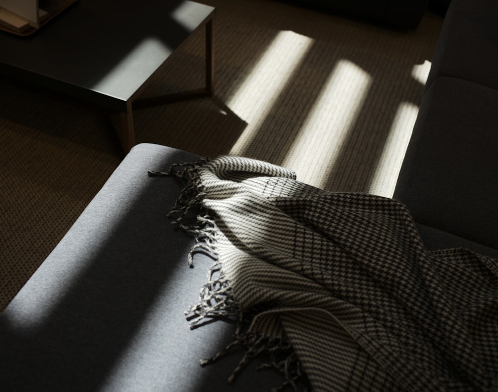 gray and black scarf on gray sectional couch