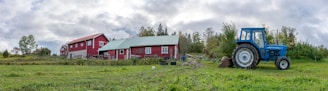 A warm, sunlit farmhouse surrounded by green fields and a tractor parked nearby, symbolizing rural life and agricultural growth.