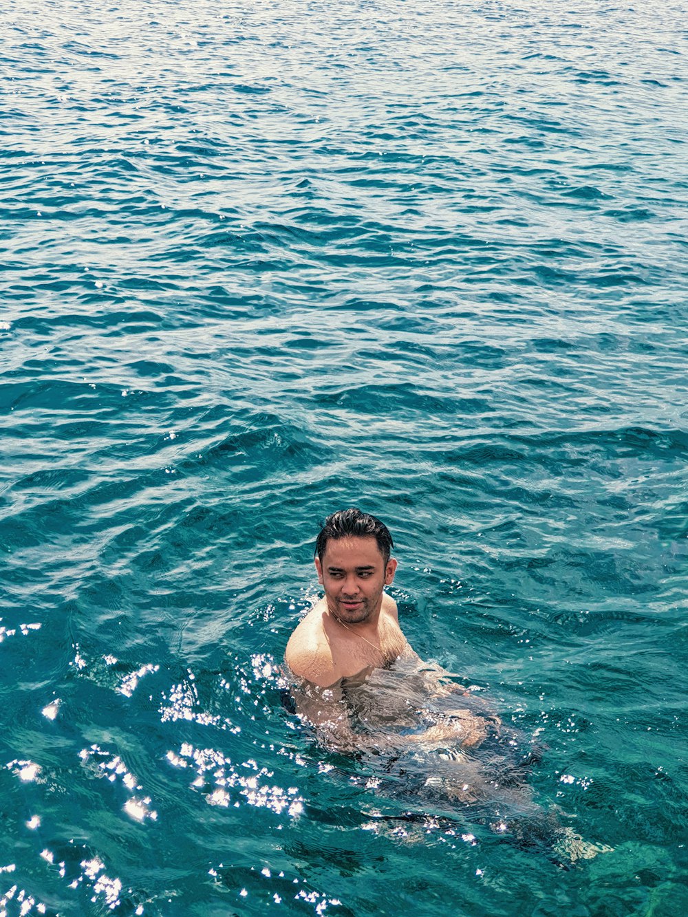 man in sea during daytime