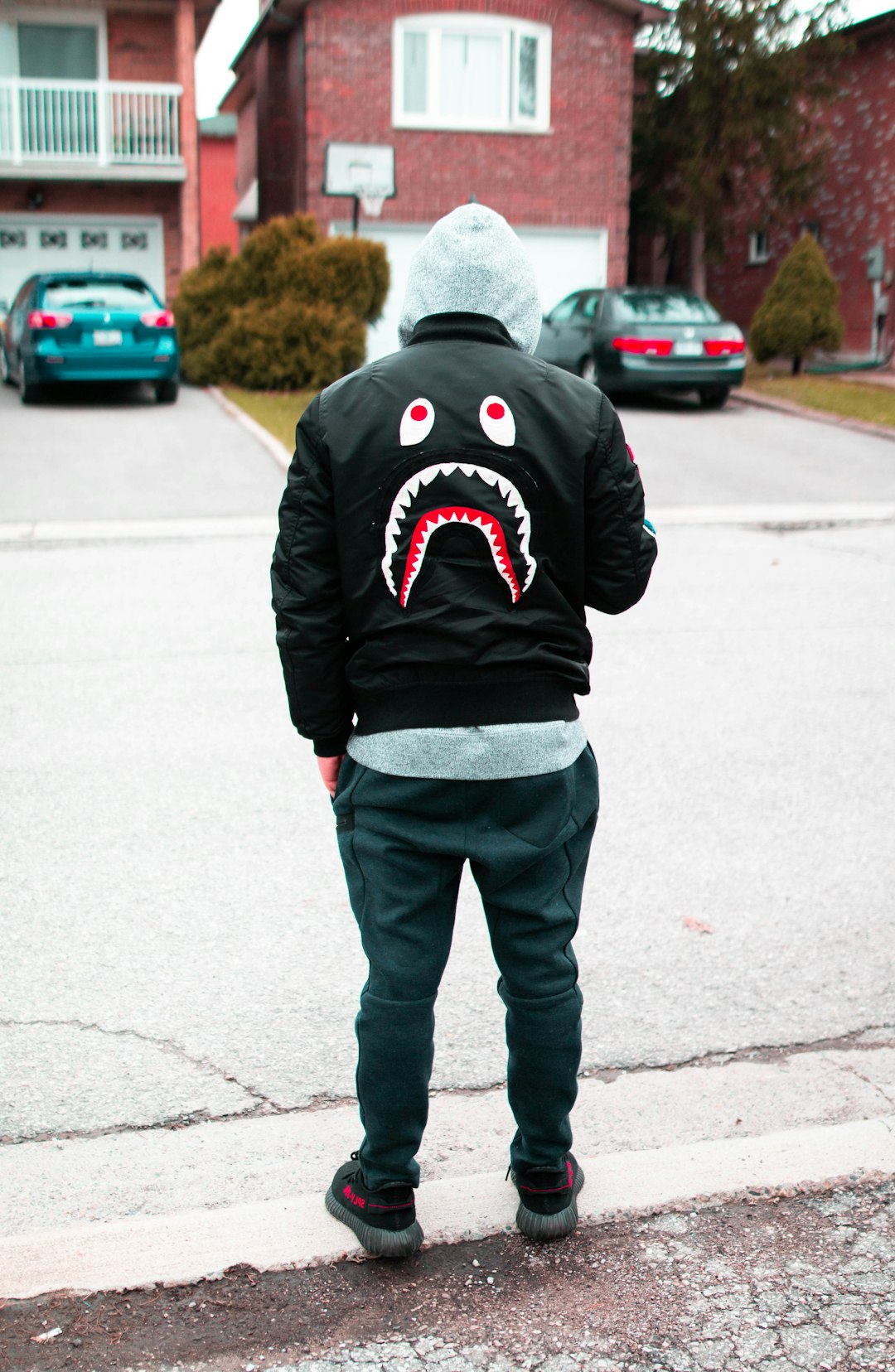 man standing beside road