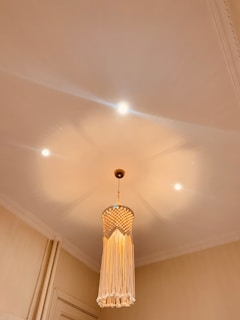 An elegant hanging pendant lamp casting soft light over a cozy reading nook