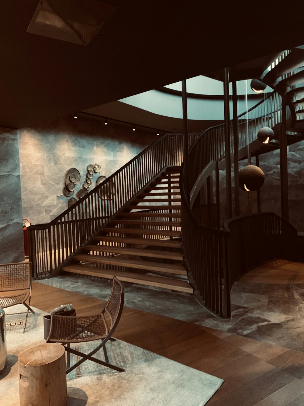 brown spiral wooden staircase inside a house