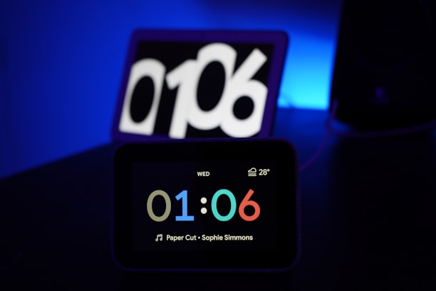 Close-up of the digital clock showing time, date, and temperature on a bright LED screen.