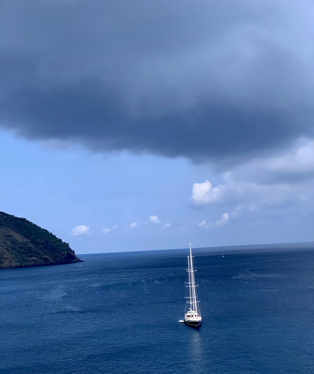 white boat under grey clouds