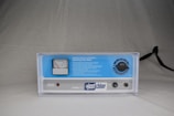 A clear, plastic-cased control unit with a blue and white interface, featuring a gauge meter on the left side, control dials, and labeled buttons. The brand 'just chlor' is prominently displayed on the front panel. The product is placed against a neutral background.