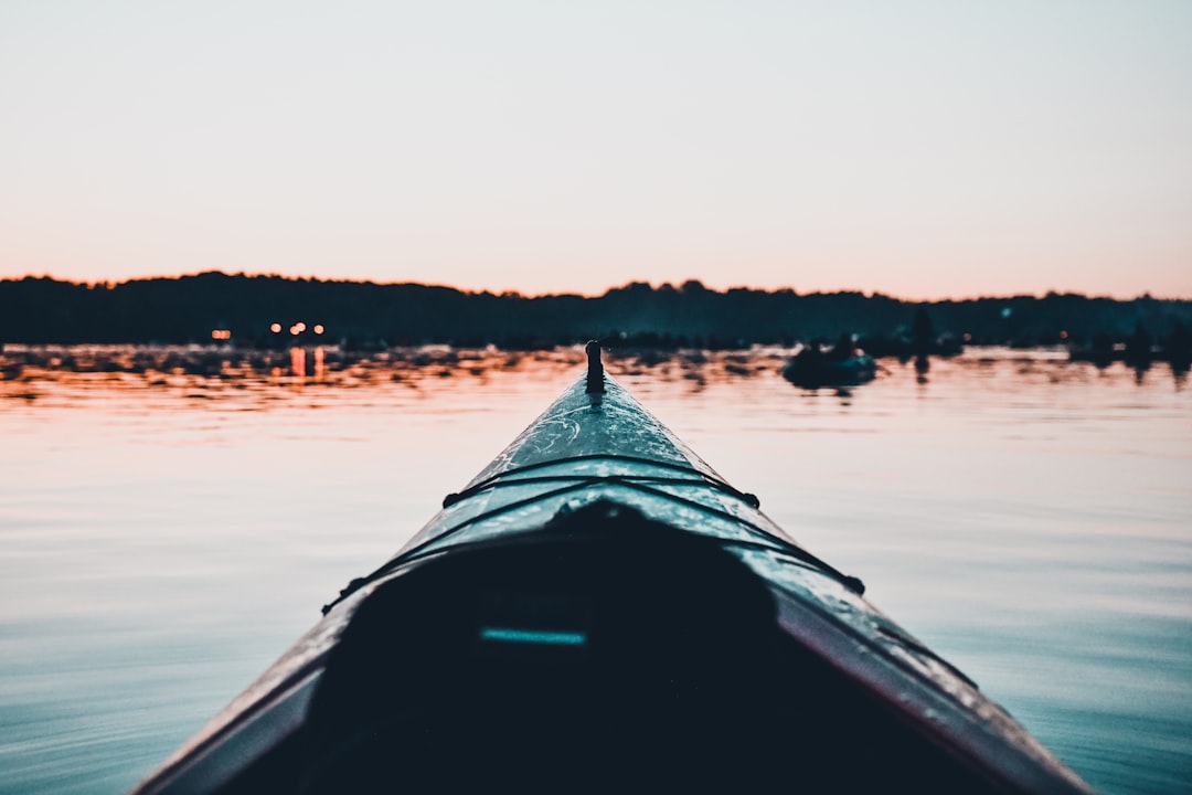 black and white boat on body of water