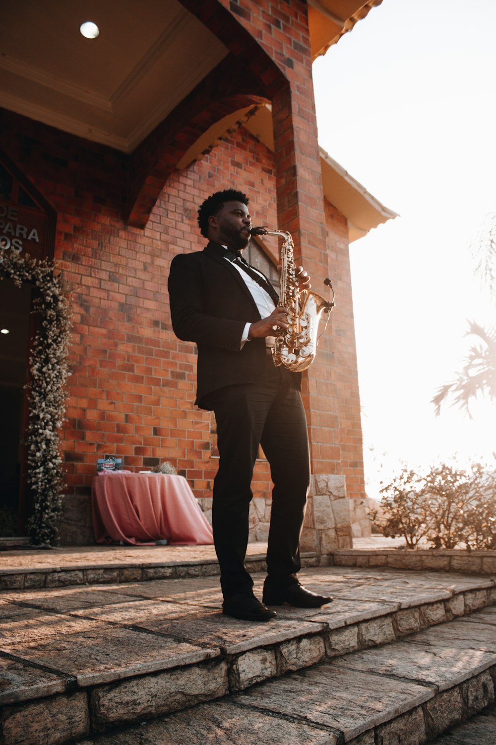 man playing saxophone during daytime