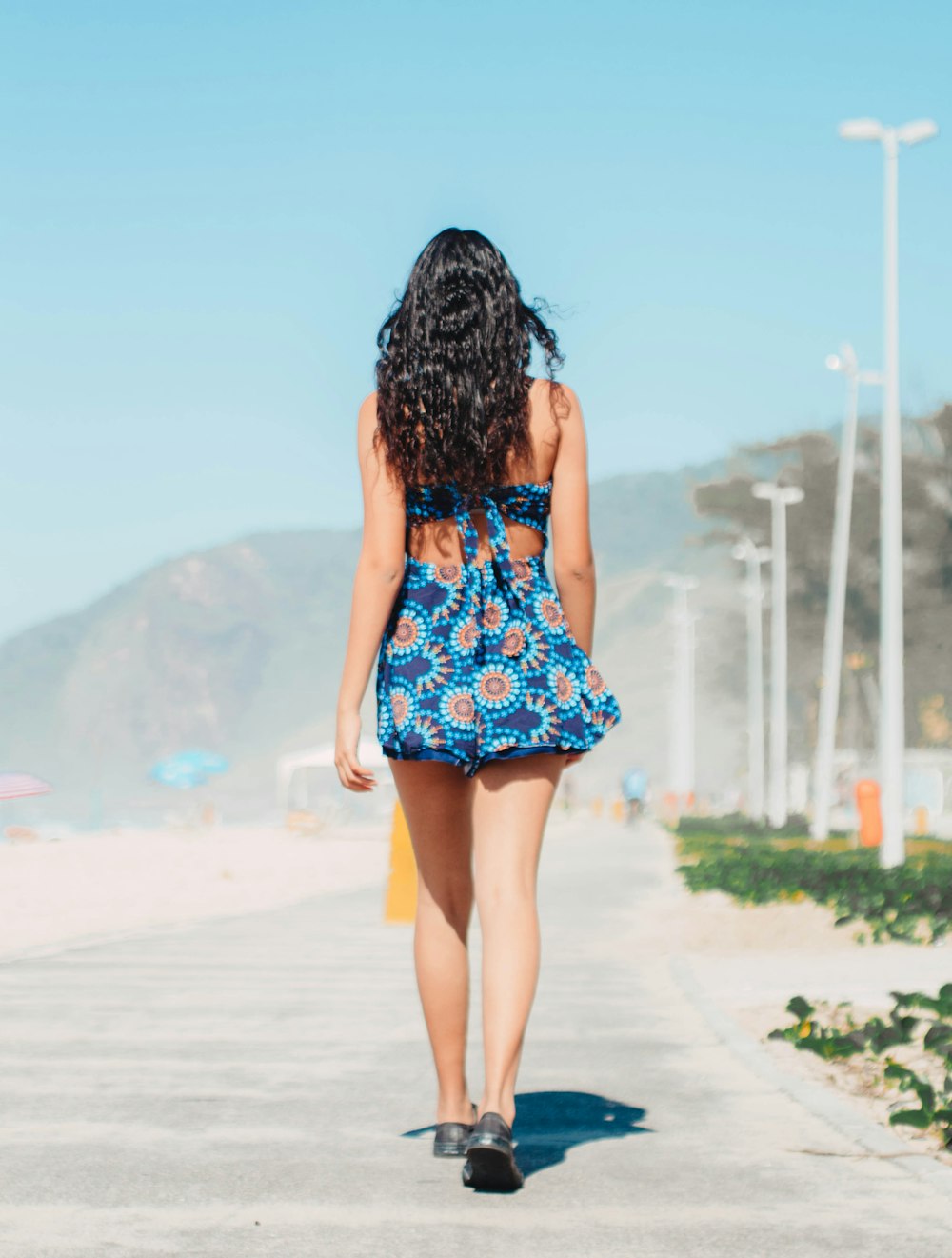 woman wearing blue and brown floral mini dress