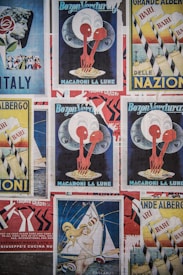 Various vintage posters with colorful and artistic designs are displayed. Central themes include Italy, macaroni, and sailing, with bold graphics and typography.
