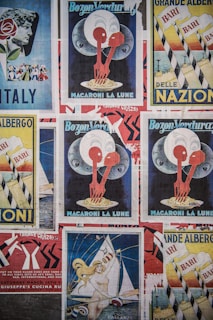 Various vintage posters with colorful and artistic designs are displayed. Central themes include Italy, macaroni, and sailing, with bold graphics and typography.